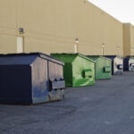 Blue,And,Green,Industrial,Garbage,Bins,Lined,Up,Outside,Along