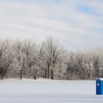 A,Port-a-potty,Sits,In,A,Remote,Field,Covered,In,Snow