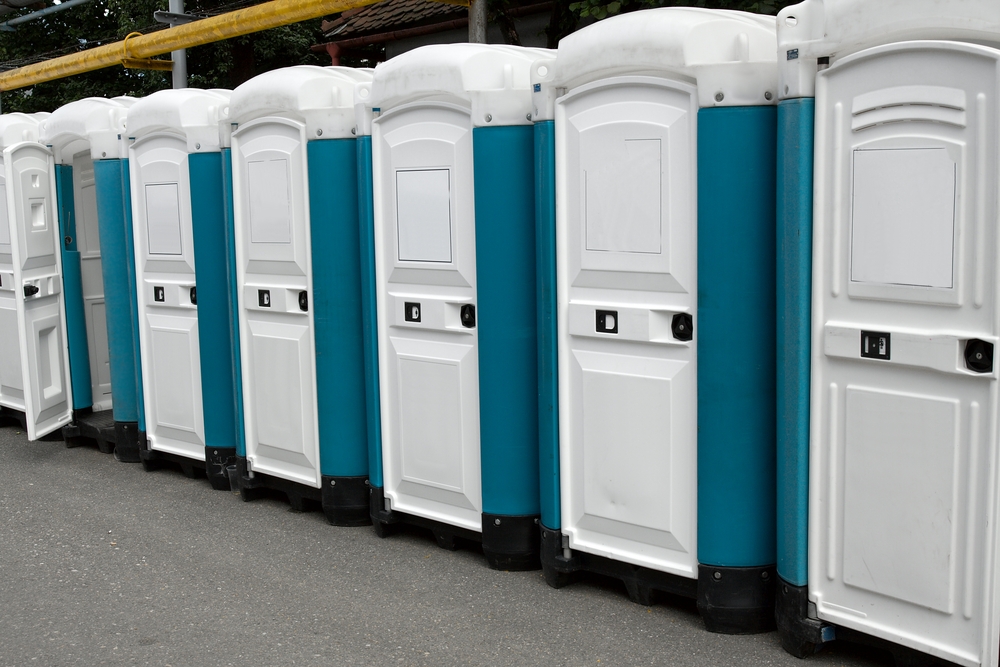 Row,Of,Portable,Toilets,At,An,Outdoor,Event